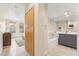 Well-lit bathroom featuring a bathtub, gray vanity, ample storage, and large mirror at 28990 N White Feather E Ln # 182, Scottsdale, AZ 85262