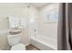 Bright bathroom featuring a shower over a tub, wood-look flooring, and a window for natural light at 28990 N White Feather E Ln # 182, Scottsdale, AZ 85262