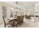 Elegant dining room with a large table, stylish chairs, and a mirrored wall for added depth at 28990 N White Feather E Ln # 182, Scottsdale, AZ 85262