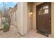 Welcoming front entry with a dark wood door, stylish light fixture, and desert landscaping at 28990 N White Feather E Ln # 182, Scottsdale, AZ 85262