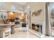 Well-lit kitchen area featuring a cozy fireplace, stainless steel appliances, and ample cabinet space at 28990 N White Feather E Ln # 182, Scottsdale, AZ 85262