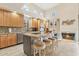 Bright, open kitchen features an island with bar seating, fireplace, and stainless steel appliances at 28990 N White Feather E Ln # 182, Scottsdale, AZ 85262
