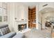 Cozy living room featuring a fireplace, custom built-in bookshelves with ladder, and neutral decor at 28990 N White Feather E Ln # 182, Scottsdale, AZ 85262