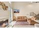 Spacious living room with a fireplace, comfortable seating, and a staircase leading to the upper level at 28990 N White Feather E Ln # 182, Scottsdale, AZ 85262