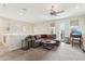 Comfortable living room with ceiling fan, modern decor, and a sliding glass door to the outside at 28990 N White Feather E Ln # 182, Scottsdale, AZ 85262
