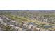 Expansive aerial view of a residential community, showcasing the surrounding golf course and a serene pond at 30419 N Plantation Dr, San Tan Valley, AZ 85143