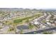 Beautiful aerial view of a well-planned residential area with a golf course, pond, and neatly lined houses at 30419 N Plantation Dr, San Tan Valley, AZ 85143