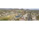Scenic aerial view of a residential community near a golf course, complete with lush greenery and a tranquil pond at 30419 N Plantation Dr, San Tan Valley, AZ 85143