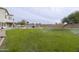 A spacious backyard featuring a built in grill, waterfall, grassy area and mature trees at 30419 N Plantation Dr, San Tan Valley, AZ 85143