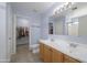 Bright bathroom featuring double sinks, tile flooring, and a walk-in closet for ample storage at 30419 N Plantation Dr, San Tan Valley, AZ 85143