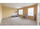 Spacious bedroom with a treadmill and lots of natural light from the bright windows at 30419 N Plantation Dr, San Tan Valley, AZ 85143
