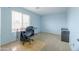 Bedroom showcasing blue walls, carpet floors, and a bright window at 30419 N Plantation Dr, San Tan Valley, AZ 85143