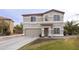 Charming two-story home with a neutral stucco exterior, tile roof, well-manicured lawn, and a two-car garage at 30419 N Plantation Dr, San Tan Valley, AZ 85143