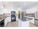 Modern kitchen with granite countertops, a black gas range, and stainless steel refrigerator at 30419 N Plantation Dr, San Tan Valley, AZ 85143
