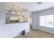Open kitchenette with granite counters, pendant lighting, and stainless appliances at 30419 N Plantation Dr, San Tan Valley, AZ 85143