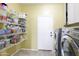 Functional laundry room with wire shelving and a side-by-side washer and dryer at 30419 N Plantation Dr, San Tan Valley, AZ 85143