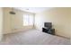 A carpeted room with a TV, media center and a bright window at 30419 N Plantation Dr, San Tan Valley, AZ 85143