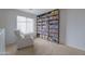 Bright loft space featuring a cozy chair and a large, fully stocked bookshelf at 30419 N Plantation Dr, San Tan Valley, AZ 85143