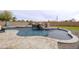 Backyard pool featuring an appealing waterfall and patio at 30419 N Plantation Dr, San Tan Valley, AZ 85143