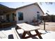 This backyard features a wooden picnic table and plenty of space for entertaining at 3721 N Brindley Ave, Litchfield Park, AZ 85340