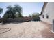 Spacious backyard featuring a rock-lined fire pit and potential for landscaping and outdoor activities at 3721 N Brindley Ave, Litchfield Park, AZ 85340