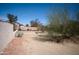 Backyard with desert landscaping and mature trees, offering privacy and natural beauty at 3721 N Brindley Ave, Litchfield Park, AZ 85340