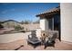 Outdoor patio area with fire pit, stylish furniture, and drought-resistant desert landscaping at 3721 N Brindley Ave, Litchfield Park, AZ 85340