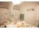 Bright bathroom featuring a double sink vanity, floral shower curtain, and coordinating decor at 3721 N Brindley Ave, Litchfield Park, AZ 85340