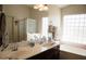 Bathroom featuring a double sink vanity, large mirror, and natural lighting at 3721 N Brindley Ave, Litchfield Park, AZ 85340