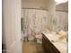 Bright bathroom featuring a double sink vanity, floral shower curtain, and coordinating decor at 3721 N Brindley Ave, Litchfield Park, AZ 85340