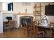 Cozy dining area with a fireplace, rustic decor, and ample natural light at 3721 N Brindley Ave, Litchfield Park, AZ 85340