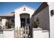 Charming front porch with vibrant flowers, a gated entrance, and wrought iron door at 3721 N Brindley Ave, Litchfield Park, AZ 85340