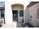 Inviting front entry showcasing a wrought iron door and colorful, decorative flower pots at 3721 N Brindley Ave, Litchfield Park, AZ 85340