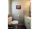 Cozy bathroom with a toilet and vanity, complemented by neutral decor and a decorative flower art piece at 4065 E University Dr # 471, Mesa, AZ 85205