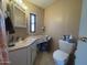 Inviting bathroom featuring a vanity with a sink and lighting, toilet, and a window providing natural light at 4065 E University Dr # 471, Mesa, AZ 85205