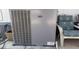 Outdoor AC unit by Carrier, next to a patio seating area, ensuring a comfortable home environment at 4065 E University Dr # 471, Mesa, AZ 85205