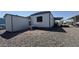 Single Gathering home featuring a gravel yard, small shed, and a covered porch area at 4065 E University Dr # 471, Mesa, AZ 85205
