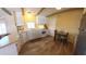 Open kitchen with white cabinets, appliances, wooden accents, and a cozy dining table with chairs at 4065 E University Dr # 471, Mesa, AZ 85205
