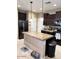 Modern kitchen featuring dark cabinetry, granite countertops, and a central island with pendant lighting at 4134 E Bellerive Dr, Chandler, AZ 85249