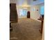 Spacious living room features carpet and a staircase leading to the upper level of the home at 4134 E Bellerive Dr, Chandler, AZ 85249