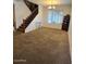 Spacious living room features carpet and a staircase leading to the upper level of the home at 4134 E Bellerive Dr, Chandler, AZ 85249