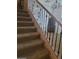 Carpeted staircase featuring dark metal railings and an open design, providing a warm, inviting transition between floors at 4134 E Bellerive Dr, Chandler, AZ 85249