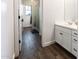 Bright bathroom featuring a white single sink vanity, wood-look tile and a window at 4381 E Rawhide St, Gilbert, AZ 85296