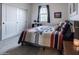 Bedroom with white walls, sliding door closet, and a Southwestern-patterned quilt on the bed at 4381 E Rawhide St, Gilbert, AZ 85296