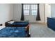 Inviting bedroom featuring two twin beds, neutral walls and carpet with plenty of natural light at 4381 E Rawhide St, Gilbert, AZ 85296
