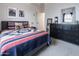 Cozy bedroom featuring a Southwestern-patterned quilt, neutral walls, and decorative accents at 4381 E Rawhide St, Gilbert, AZ 85296