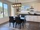 Dining area with table, chairs, a decorative light fixture, and large windows at 4381 E Rawhide St, Gilbert, AZ 85296