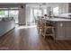 Open-concept kitchen featuring white cabinets, a center island, and a breakfast bar at 4381 E Rawhide St, Gilbert, AZ 85296