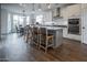 Modern kitchen with white cabinetry, stainless steel appliances, and a dining area at 4381 E Rawhide St, Gilbert, AZ 85296