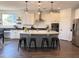 Beautiful kitchen features a gray island with seating and modern lighting at 4381 E Rawhide St, Gilbert, AZ 85296